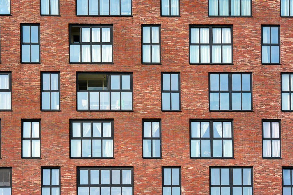 Red brick apartment building with rows of windows